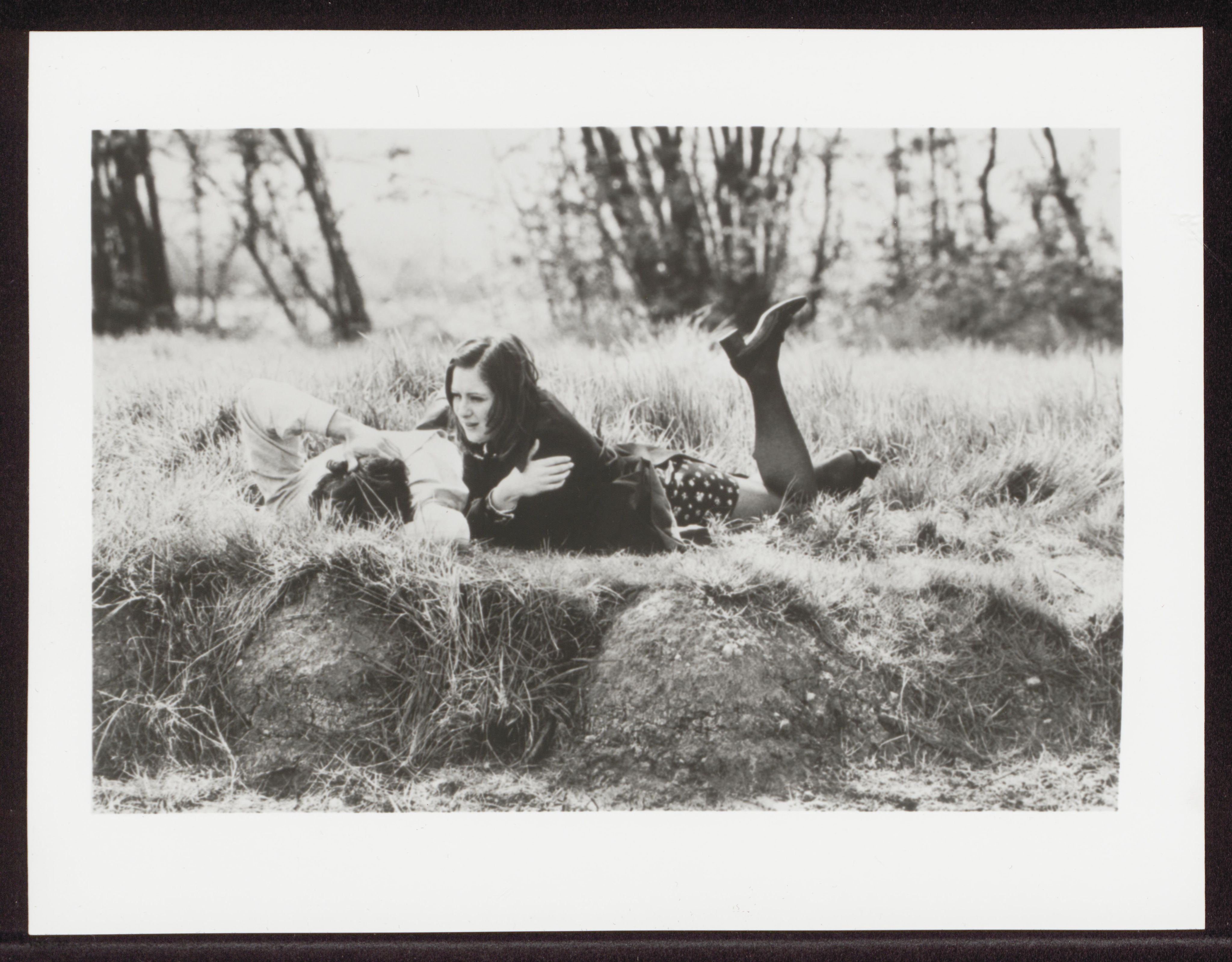 two people lying in a field