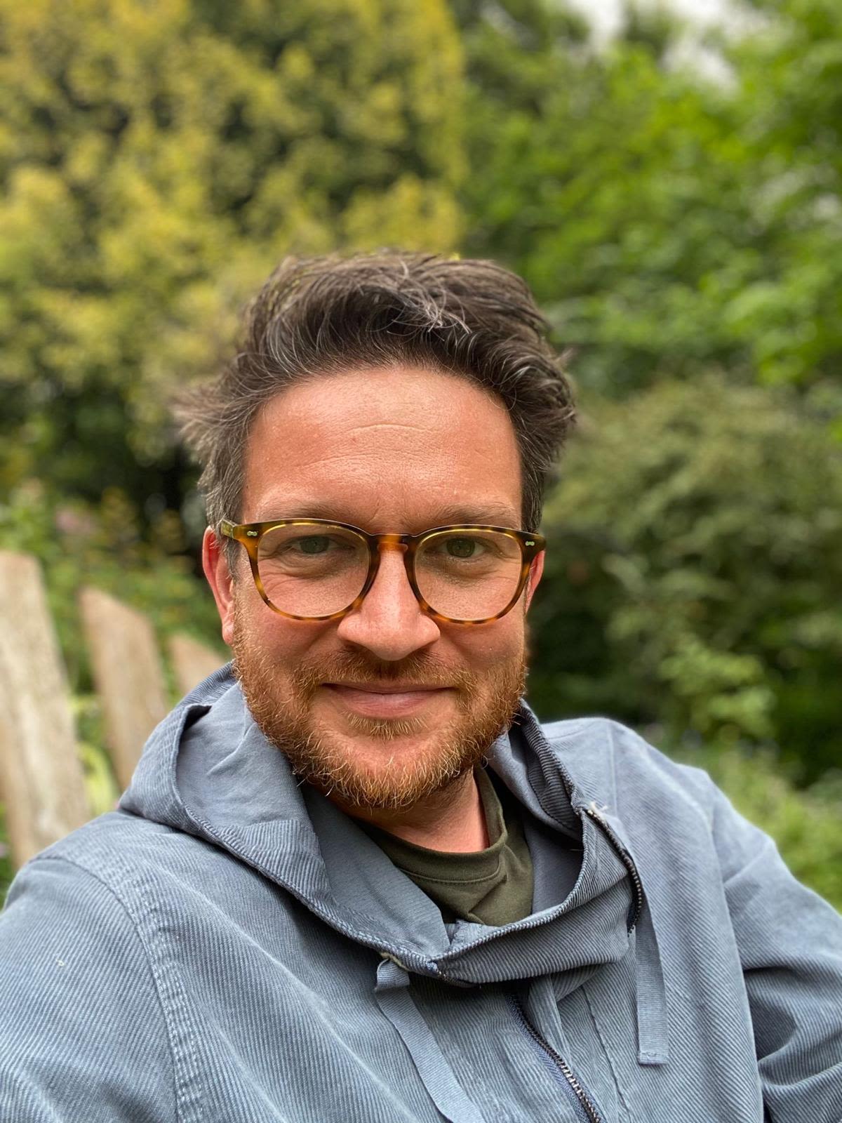 person wearing glasses looking to camera