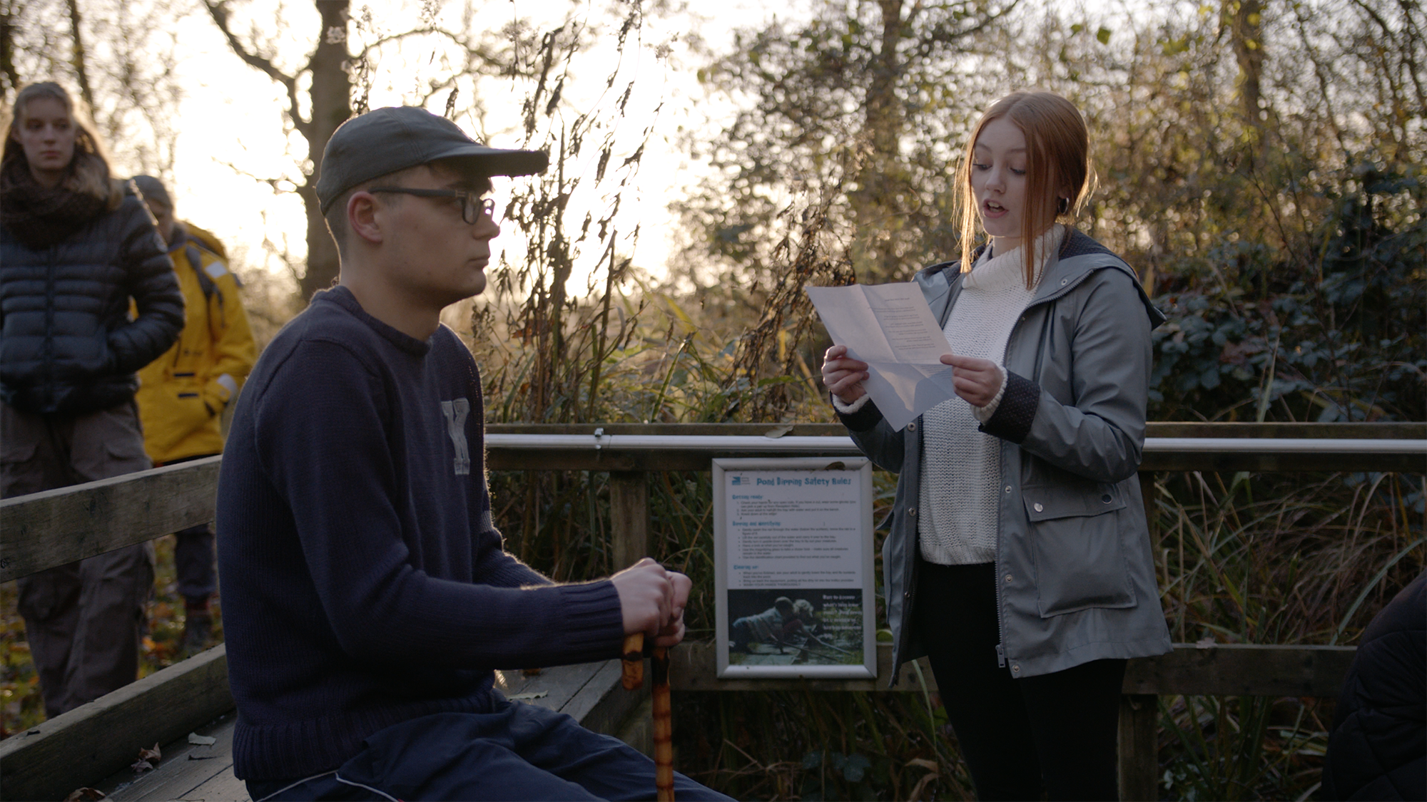 two young adults acting outdoors