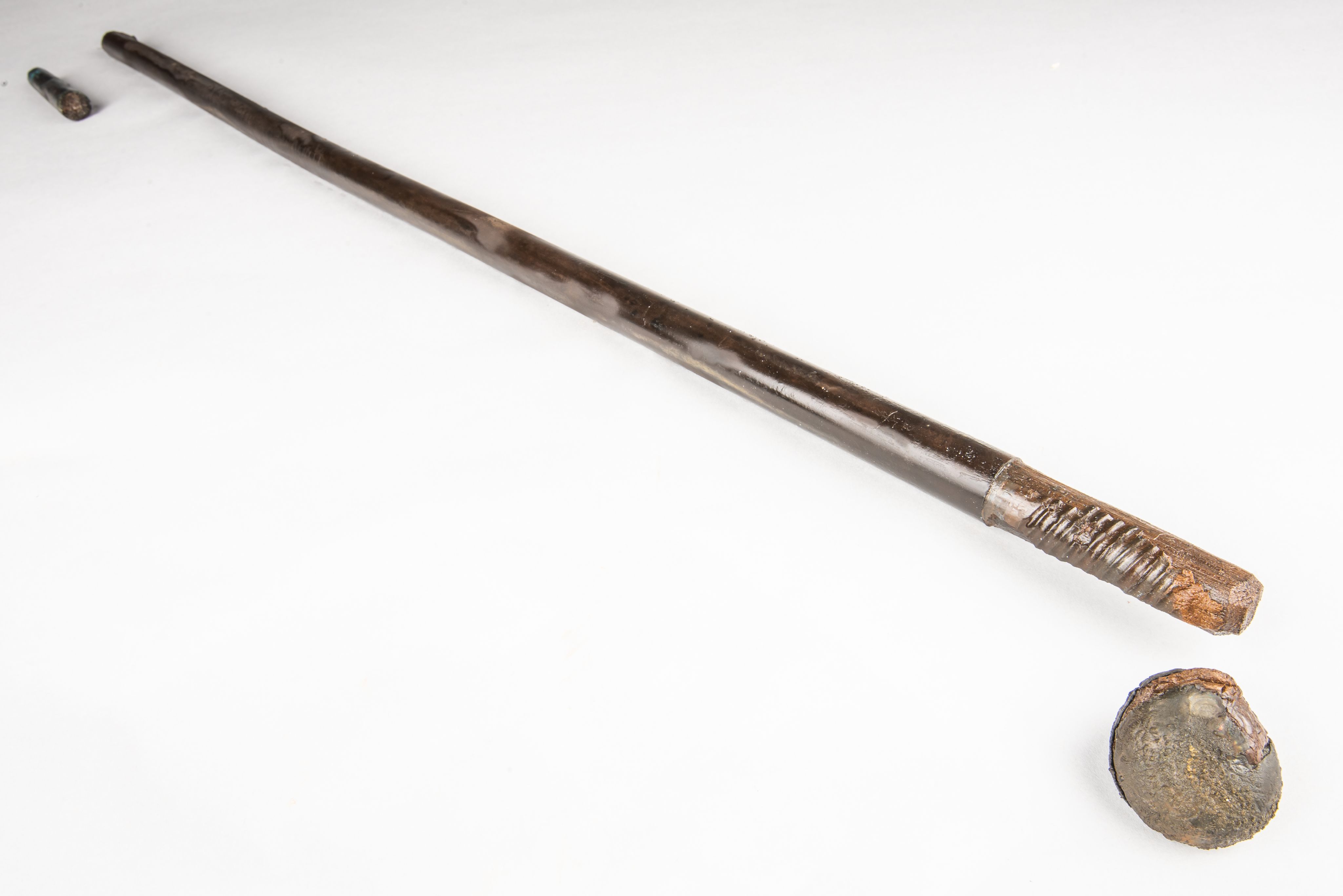 Wooden polished stick against a white background