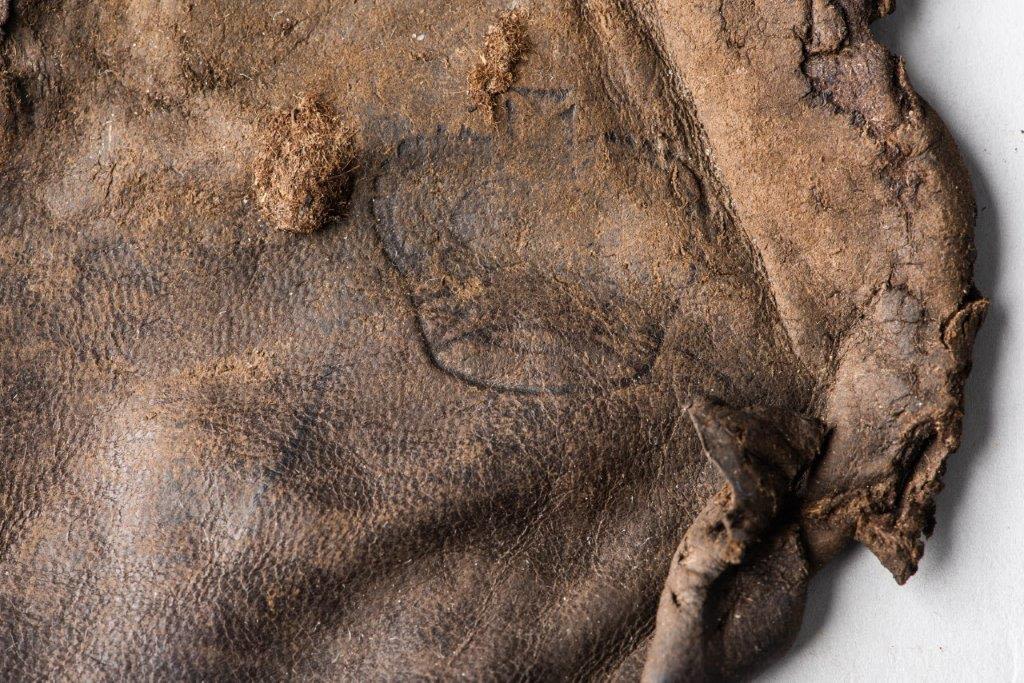 Crown symbol detail on leather pouch