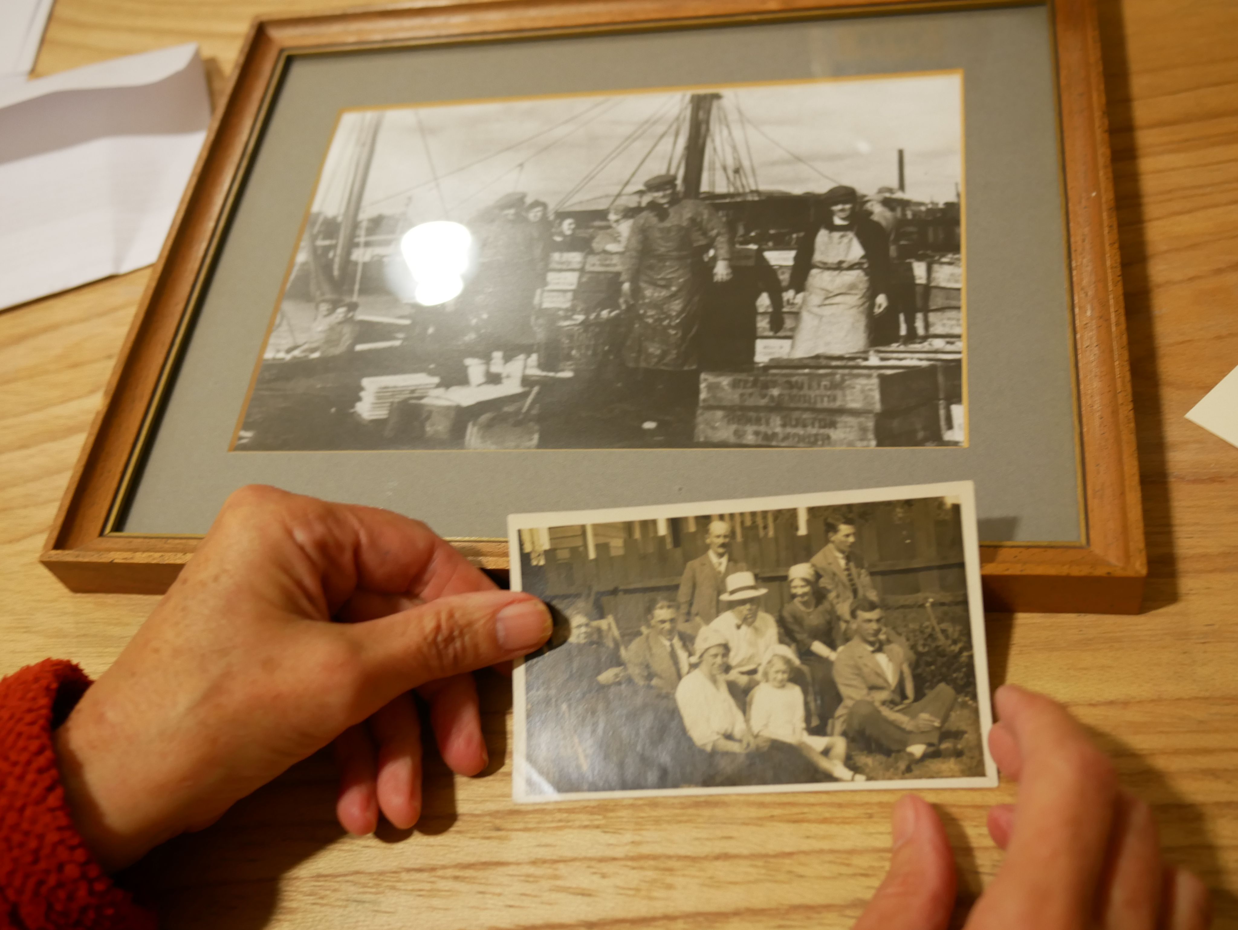 Two old black and white photographs of Great Yarmouth containing a fishing boat and it's crew and a family.