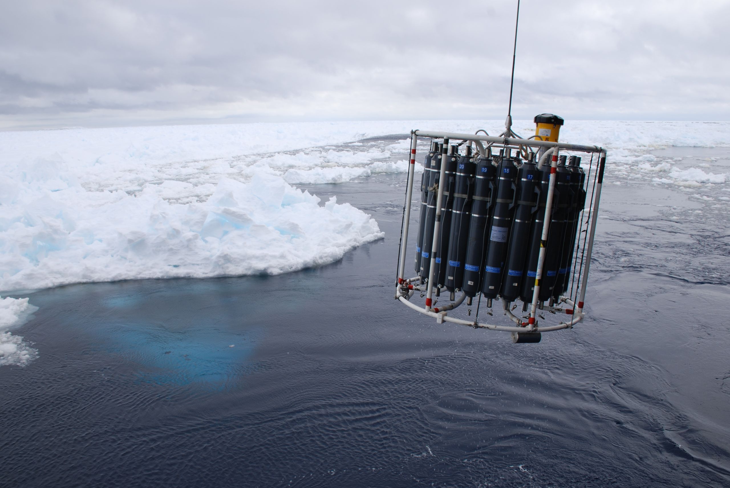 A scientific instrument being lowered into Arctic waters