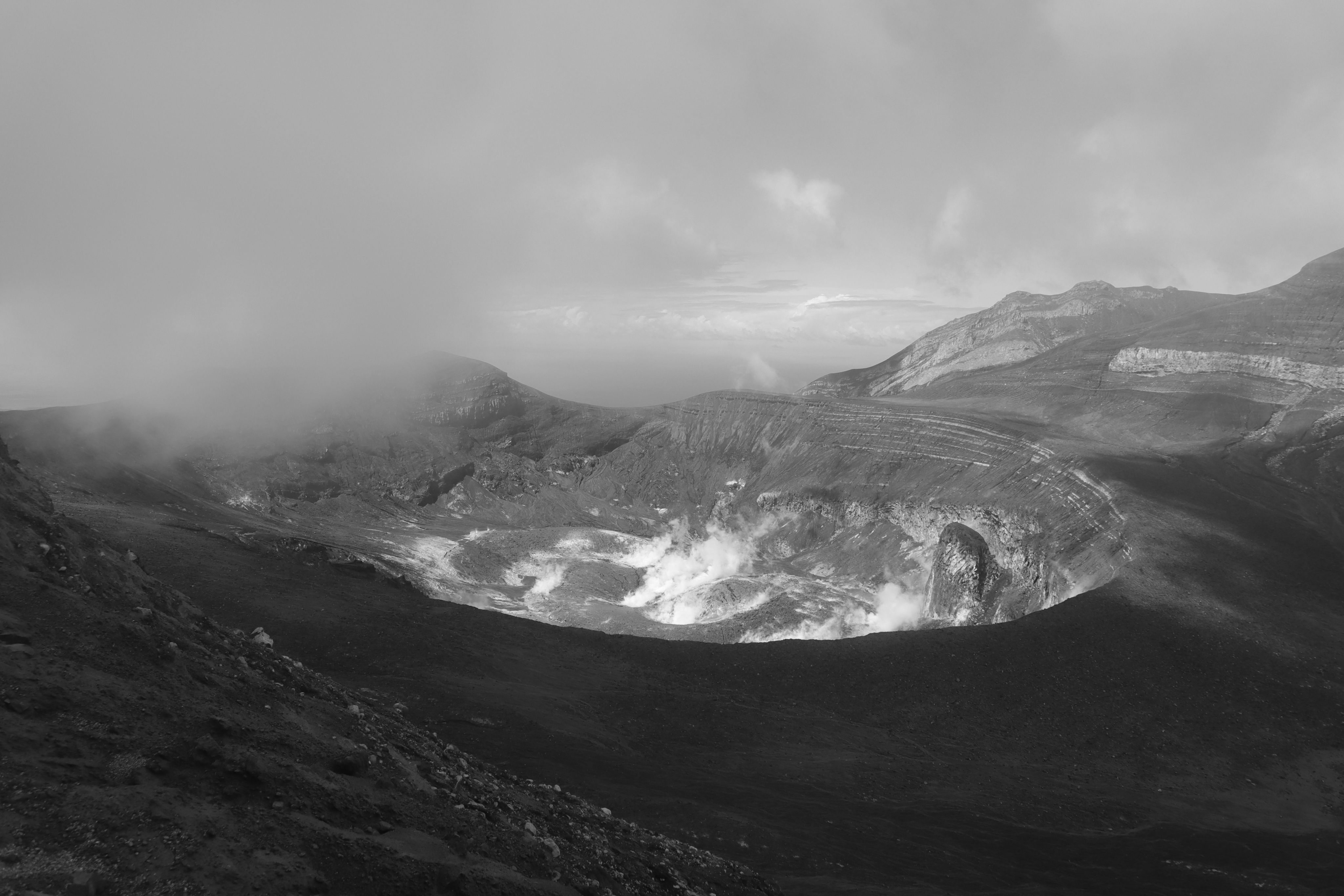 View into volcano crater, with clouds