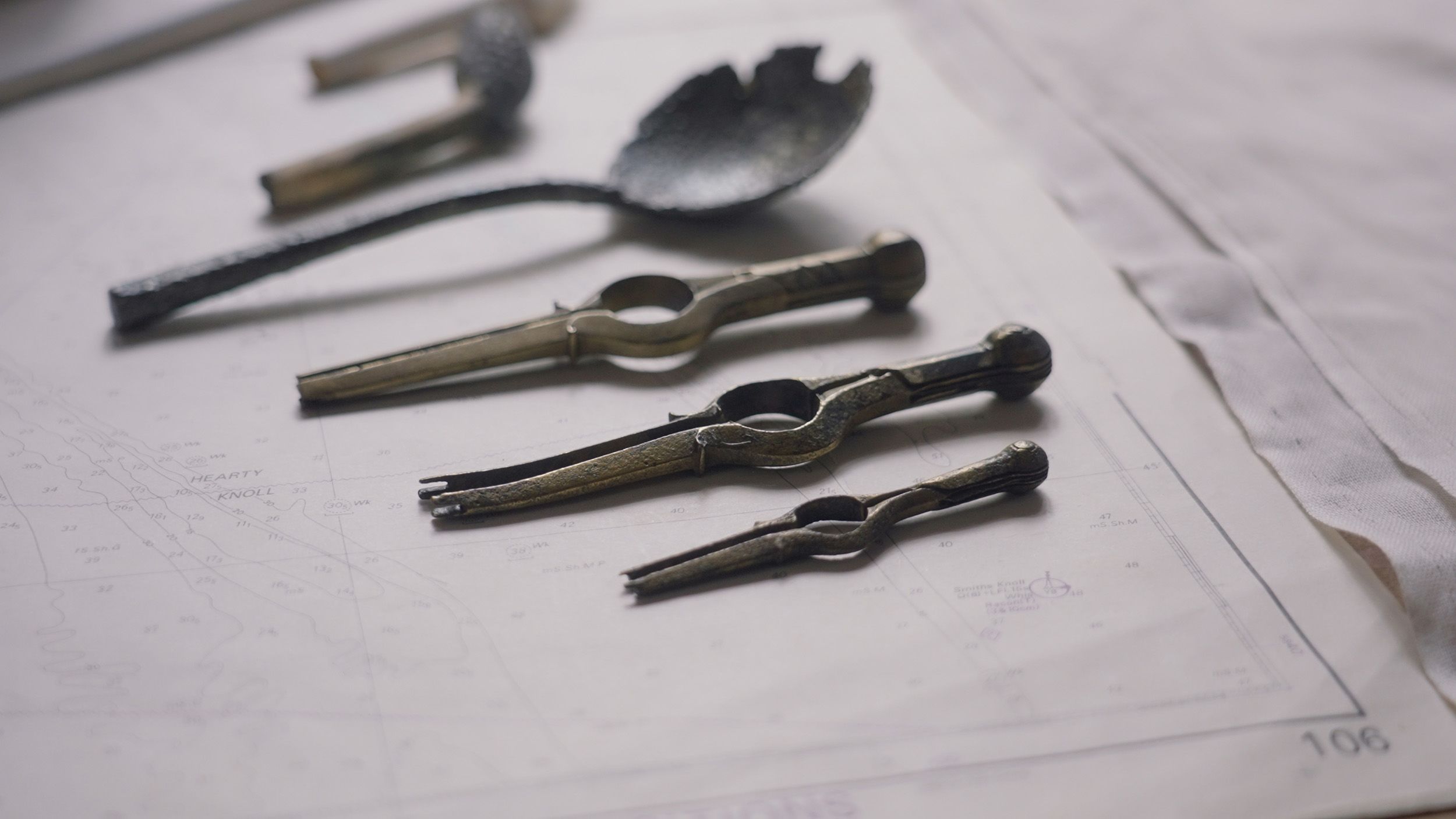 conserved metal spoon and navigational instruments
