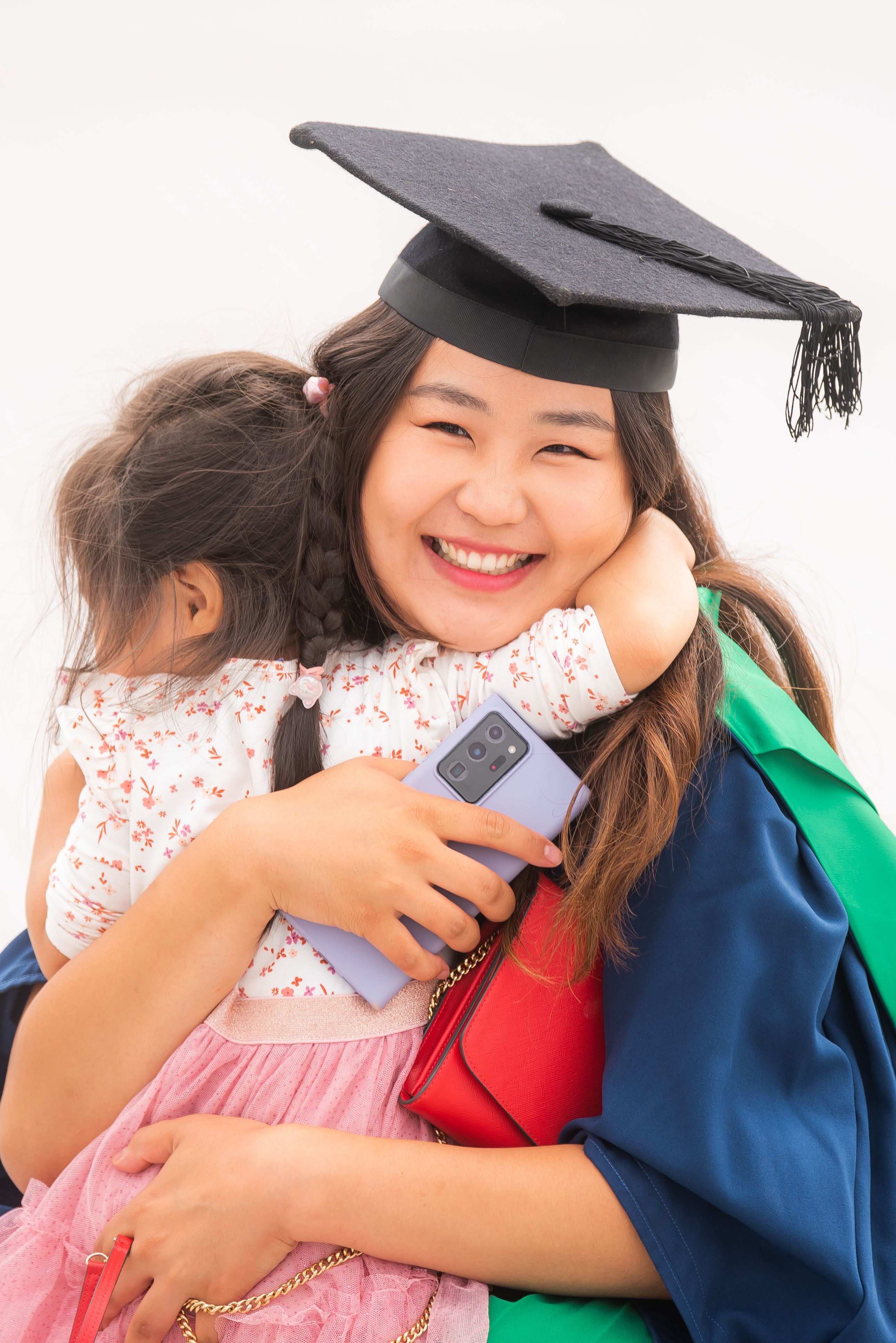 Female graduate and child