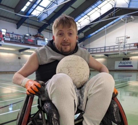 Max Levene in a wheelchair with a sports ball